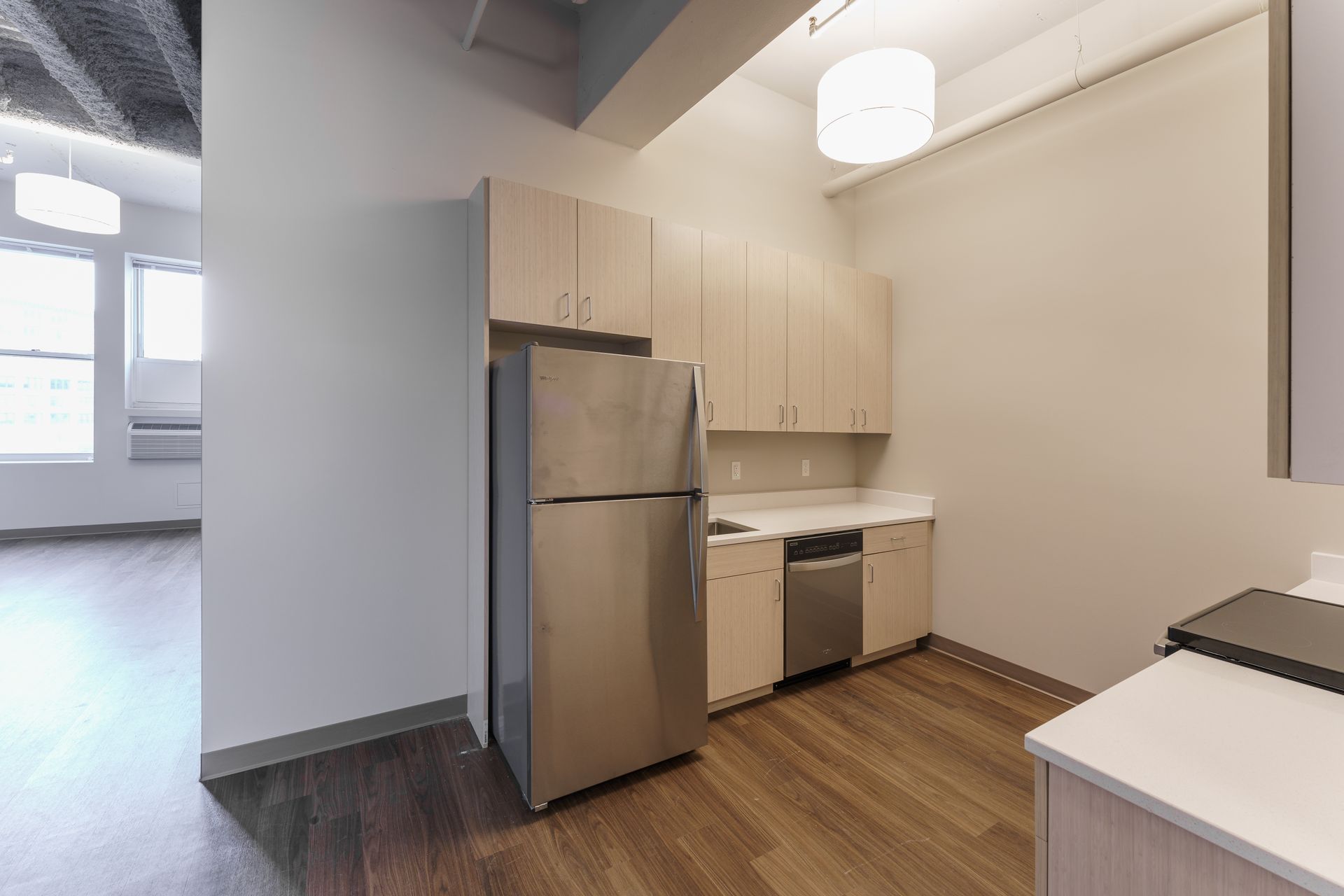 A kitchen with stainless steel appliances and wooden cabinets.