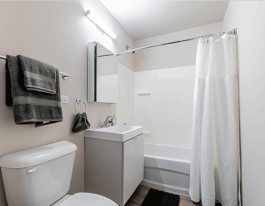 A bathroom with a toilet , sink , and bathtub.