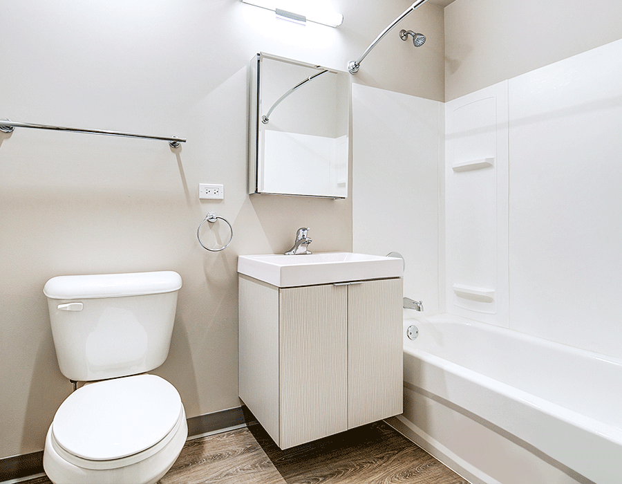A bathroom with a toilet , sink , and bathtub.
