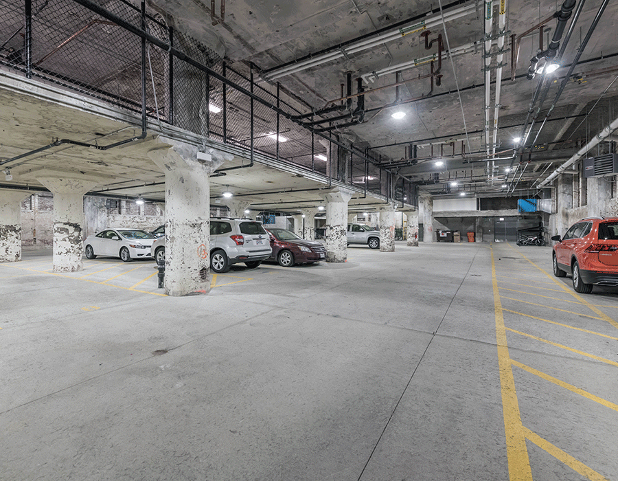 A lot of cars are parked in a parking garage.