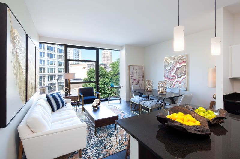 A living room with a white couch and a black counter top