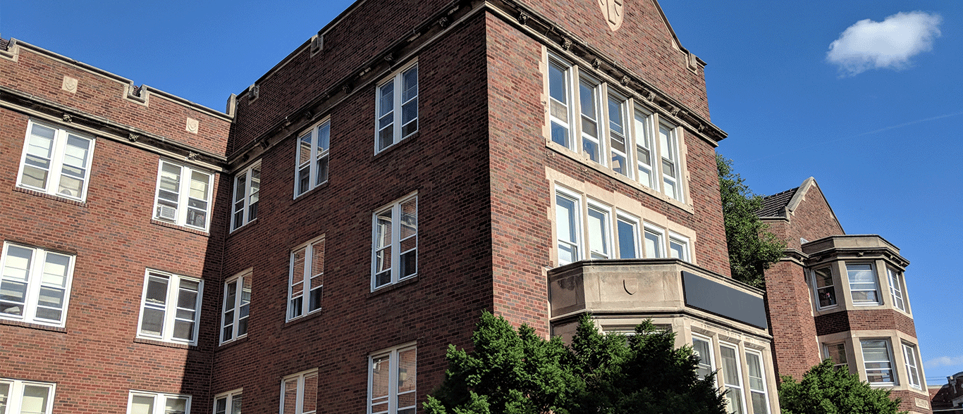 A large brick building with a blue sky in the background