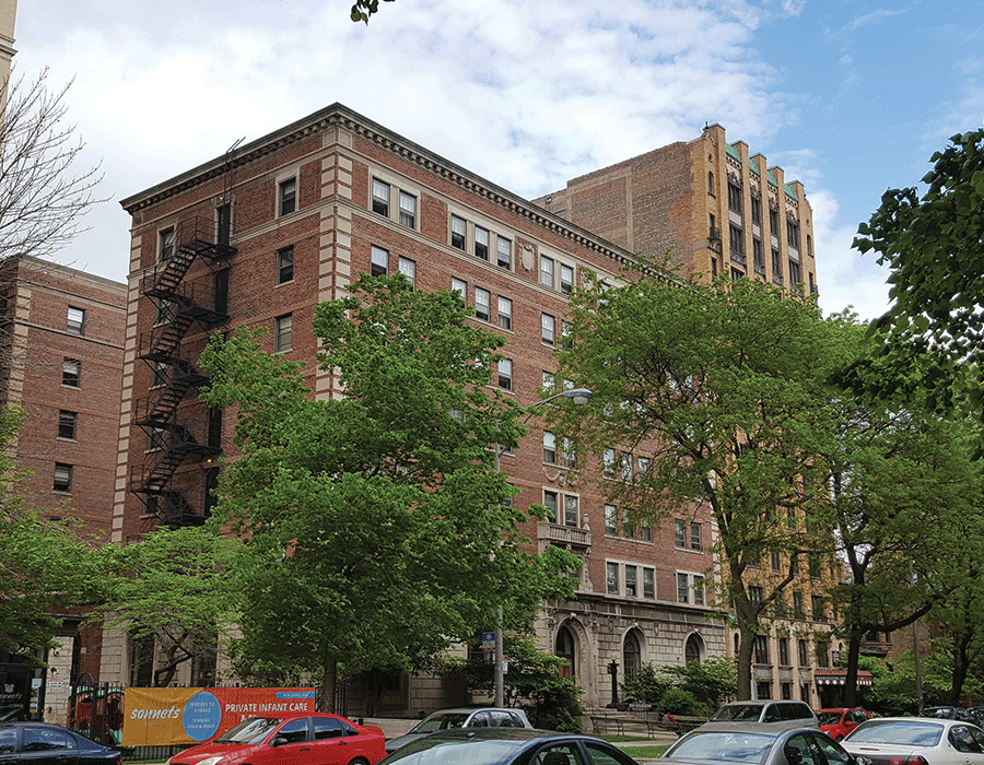 A large brick building with cars parked in front of it