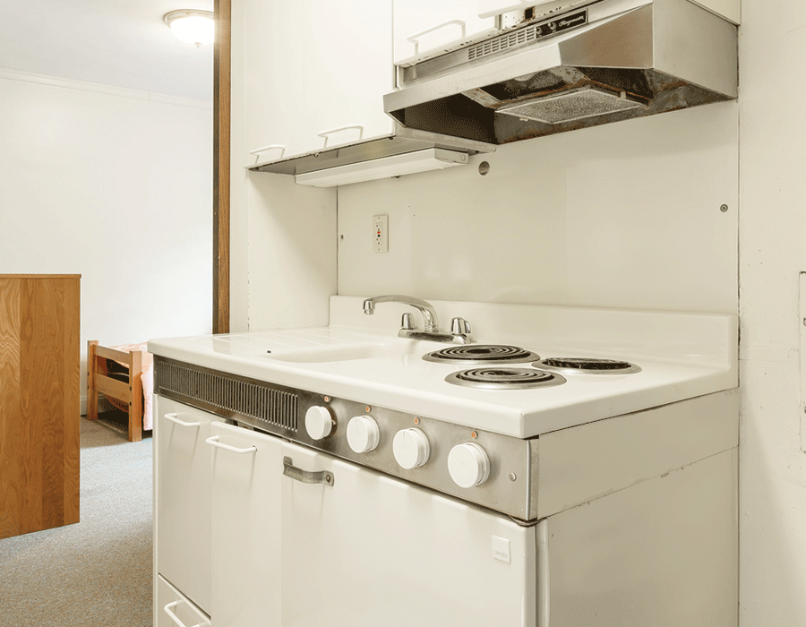 A kitchen with a stove , sink , and dishwasher.