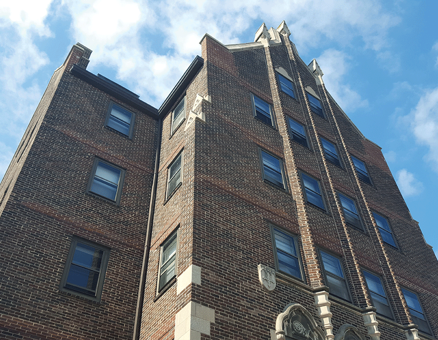 A large brick building with a blue sky in the background