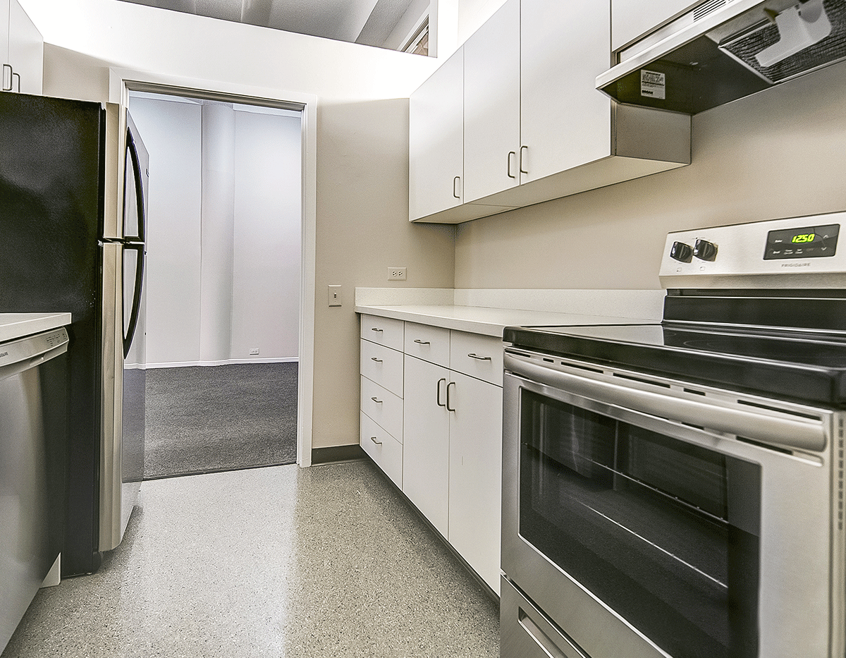 A kitchen with stainless steel appliances and white cabinets