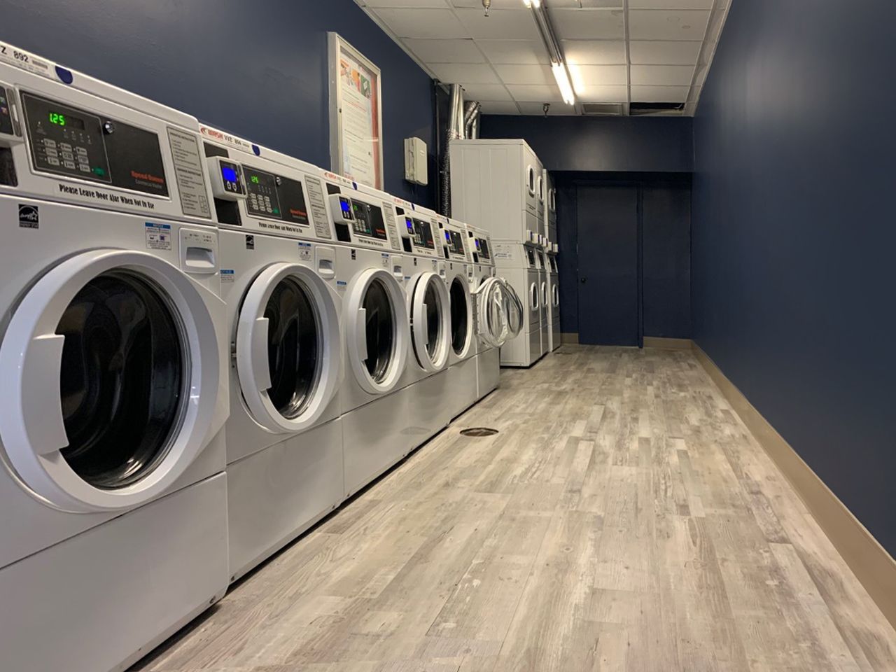 A laundromat with a lot of washers and dryers