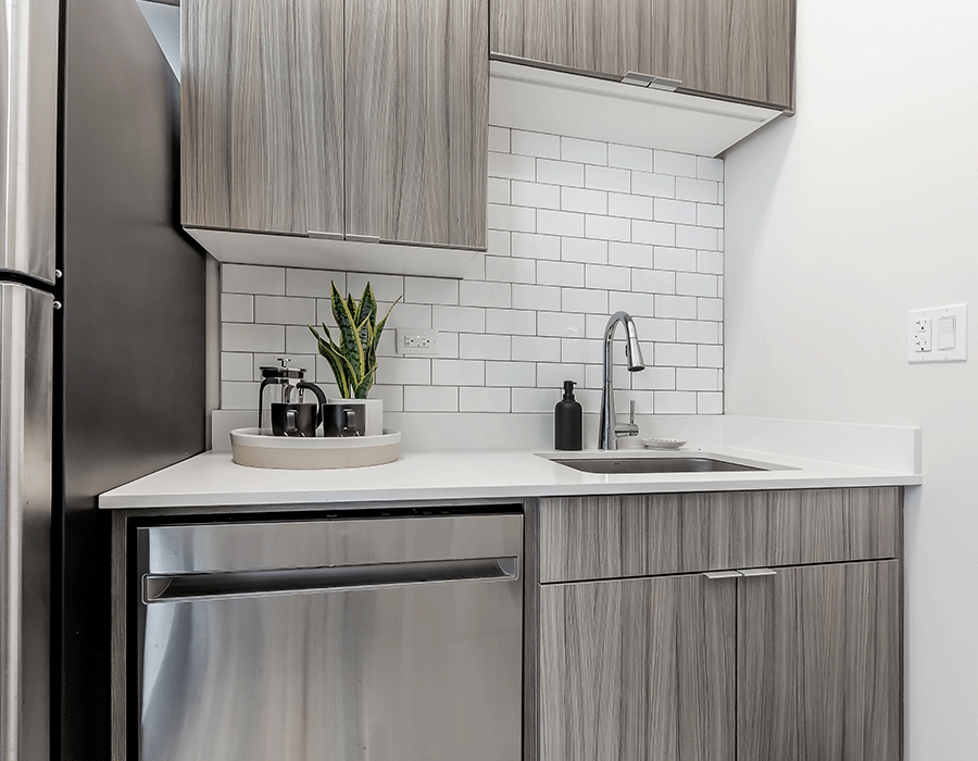 A kitchen with stainless steel appliances and wooden cabinets