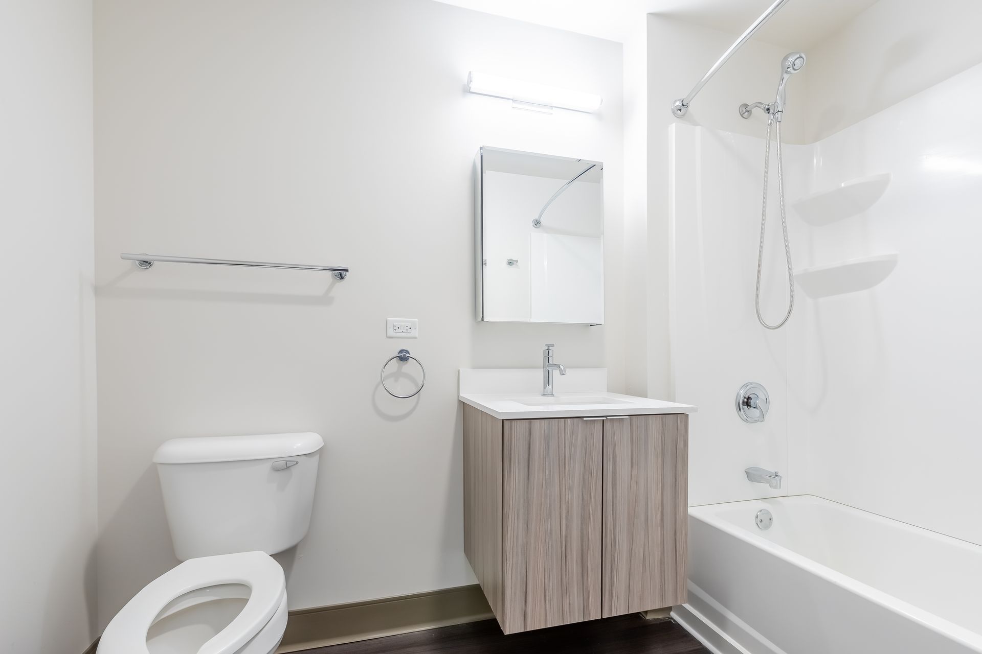 A bathroom with a toilet , sink , and bathtub.
