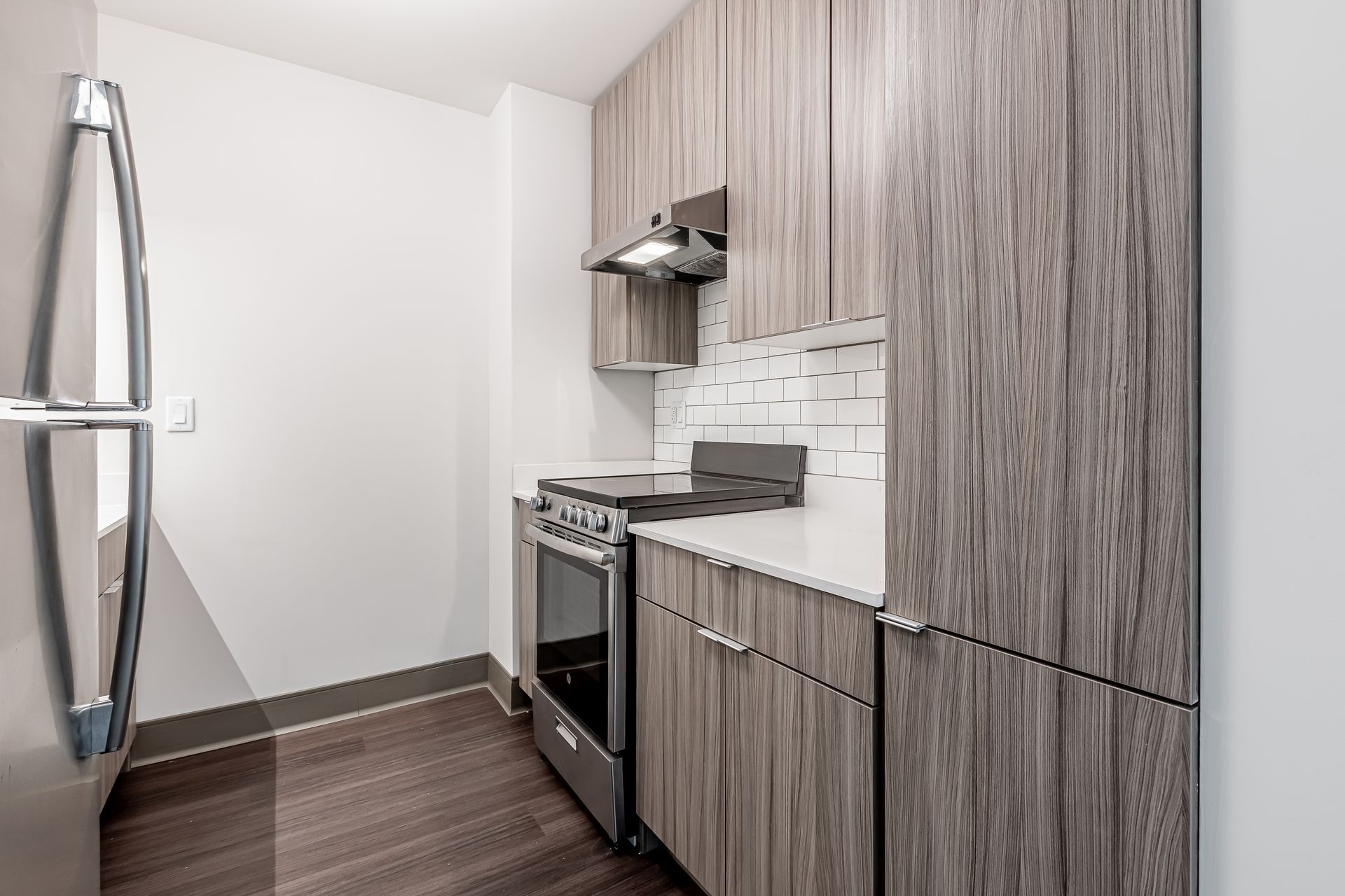 A kitchen with stainless steel appliances and wooden cabinets.