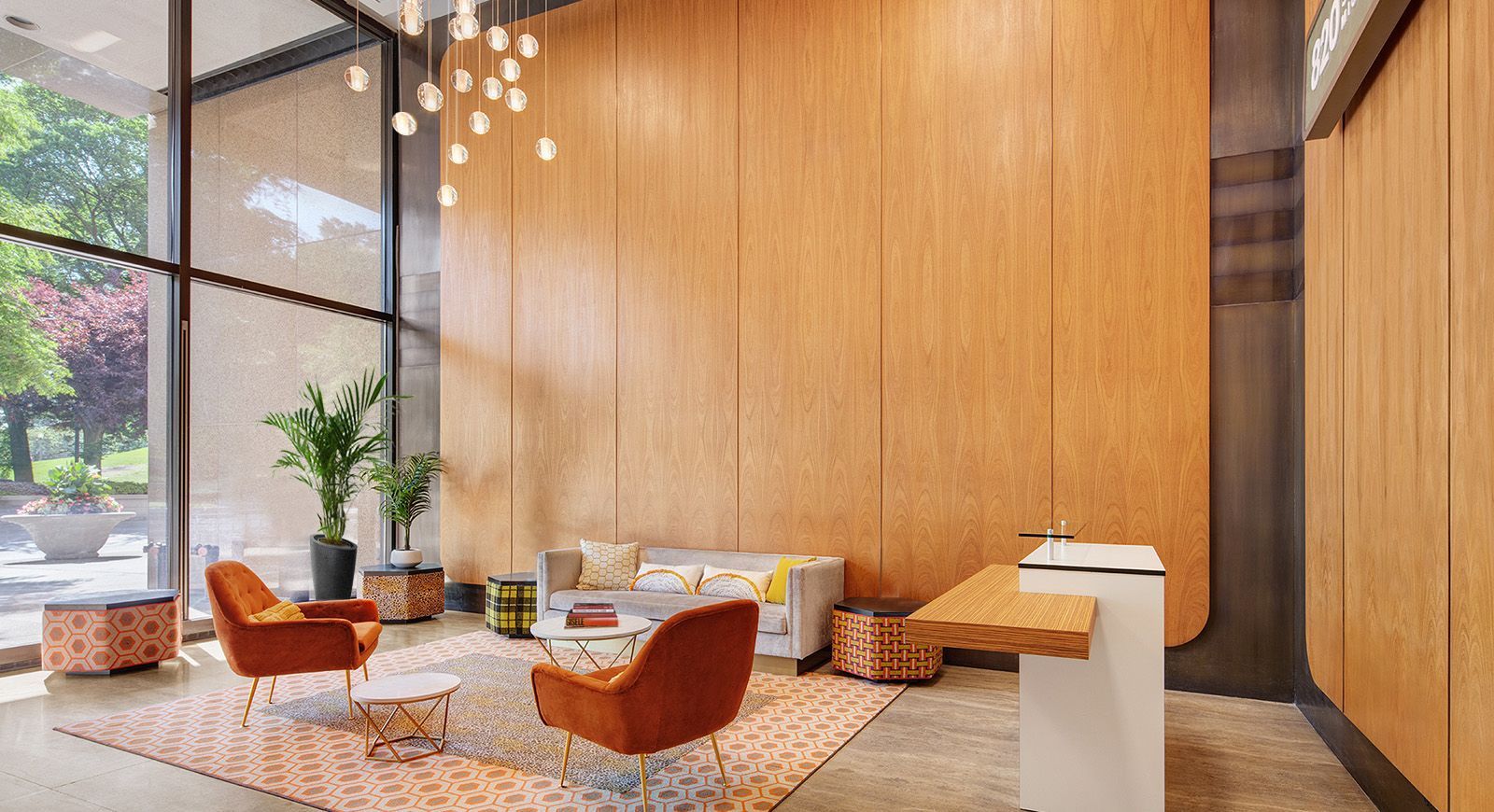 A lobby with a couch , chairs , and a table.