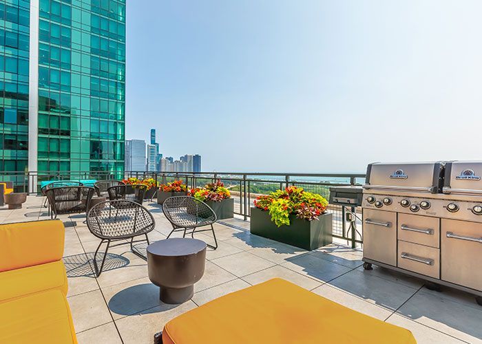 There is a grill on the roof of a building.