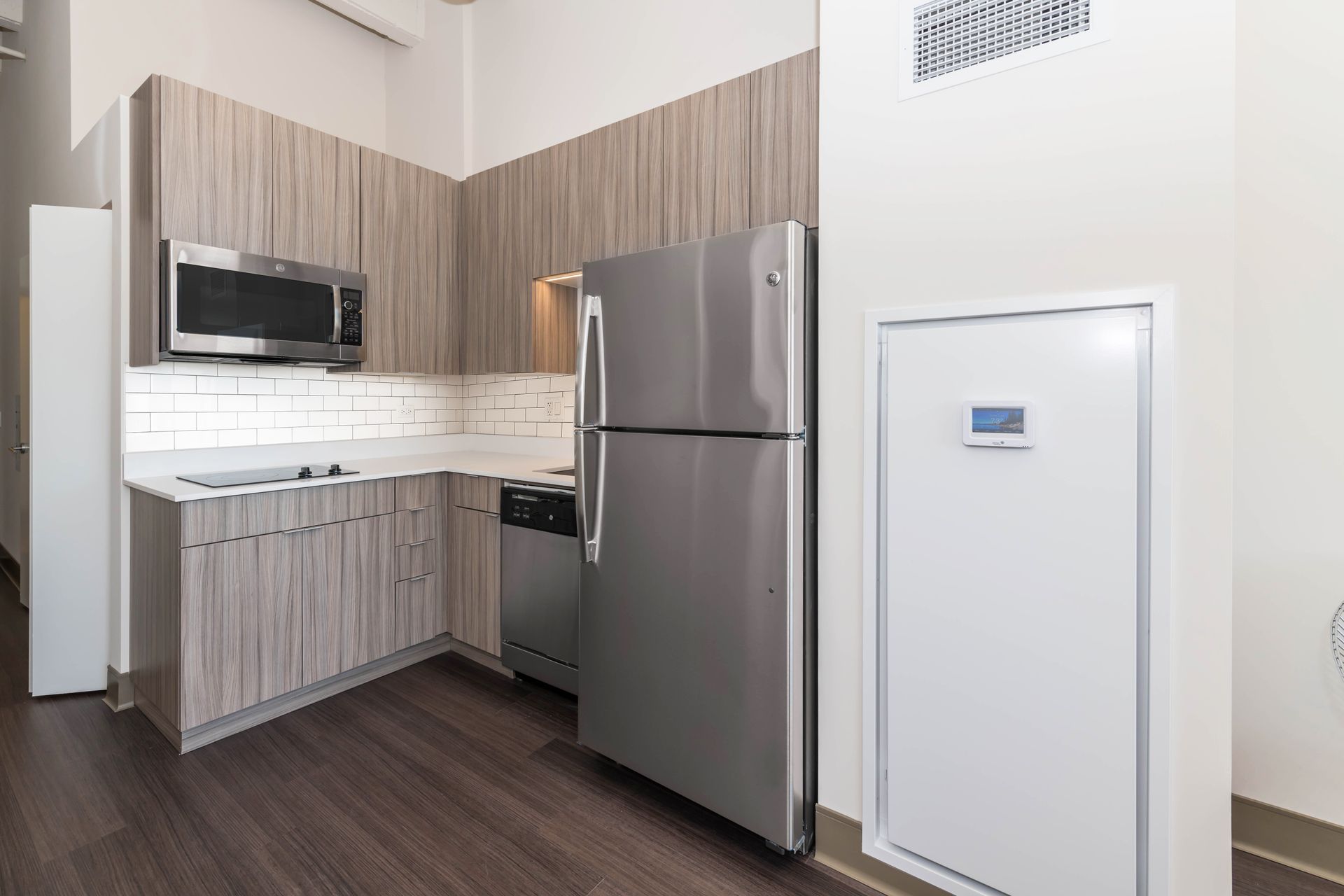 A kitchen with stainless steel appliances and wooden cabinets.