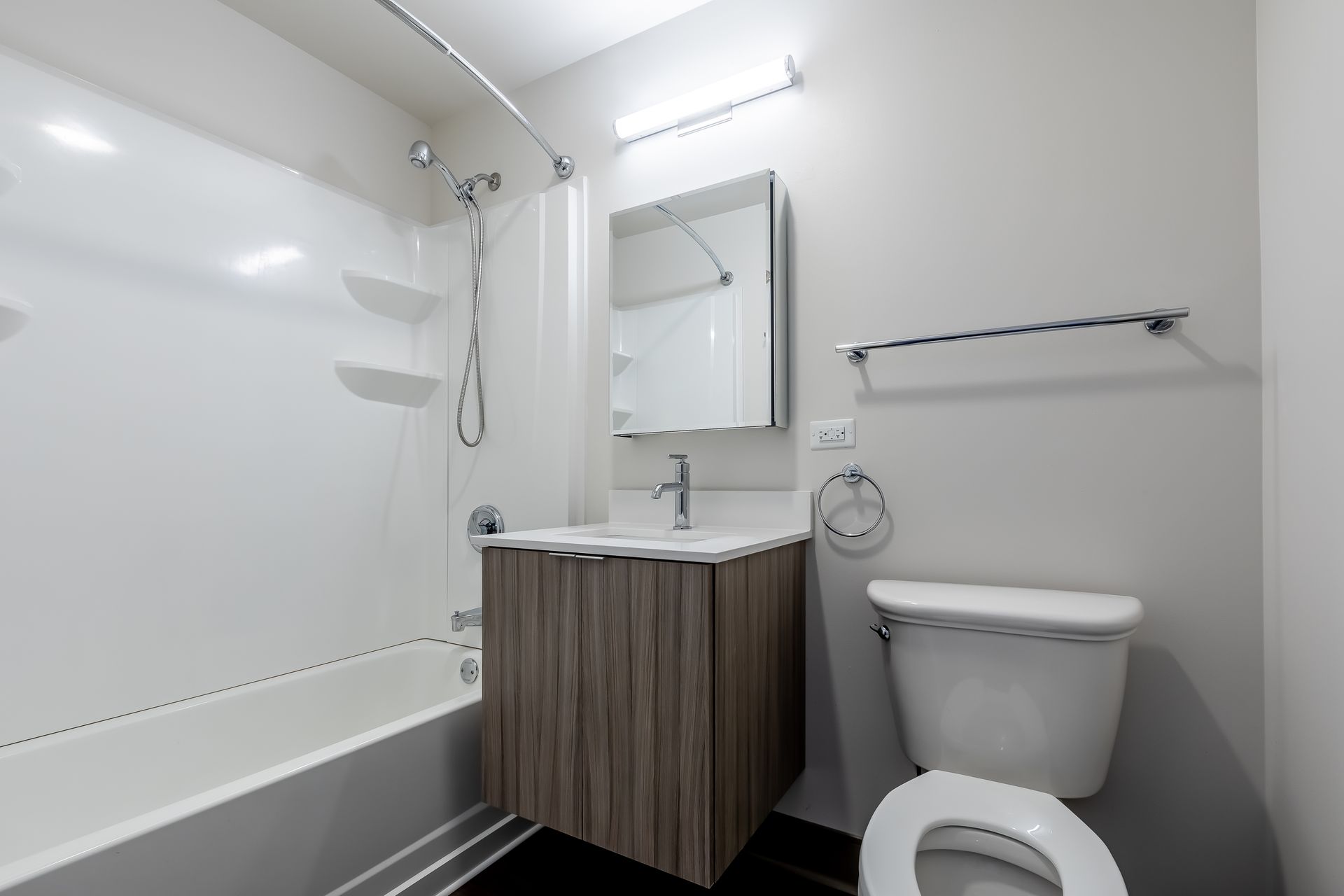 A bathroom with a toilet , sink , and bathtub.