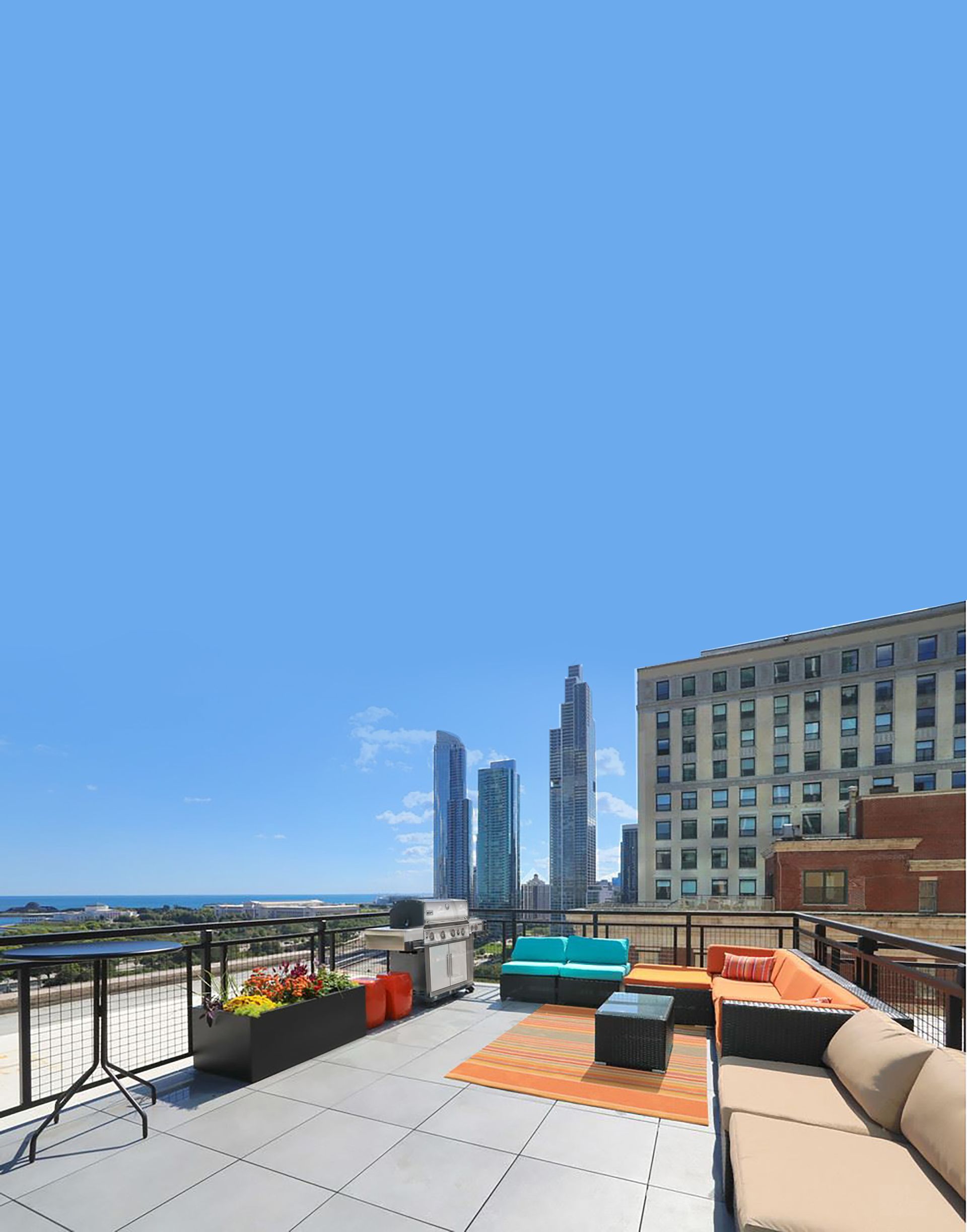 A rooftop deck with a view of the city and a couch.
