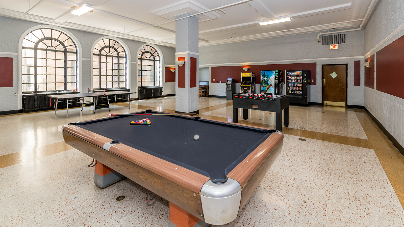 There is a pool table in the middle of the room.