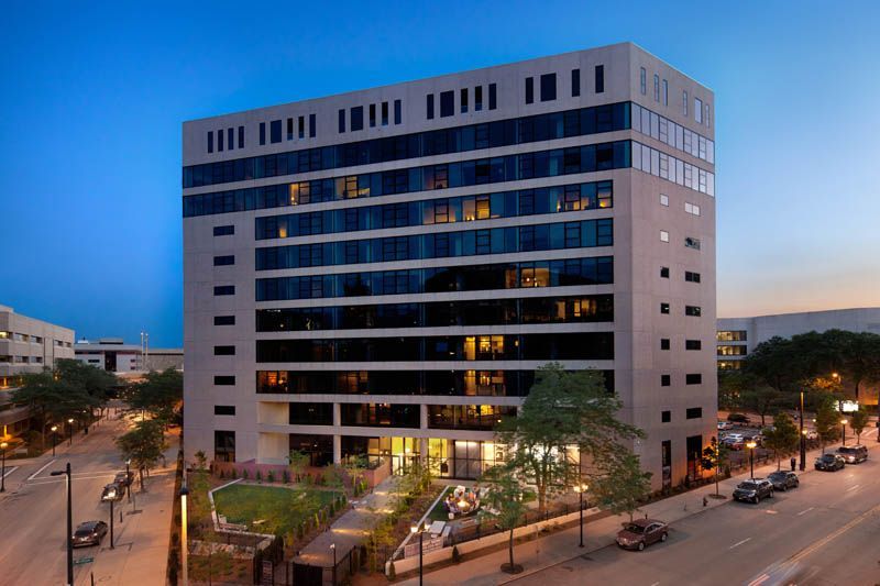 An aerial view of a large building in a city at night.