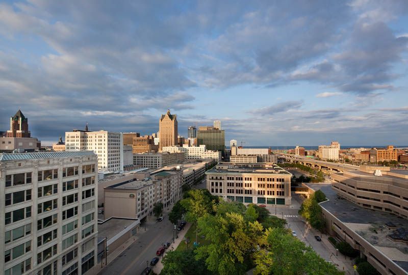 An aerial view of a city with lots of buildings and trees.