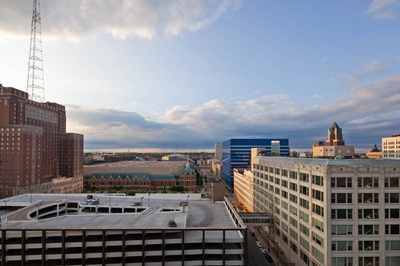 An aerial view of a city with a parking garage in the foreground.
