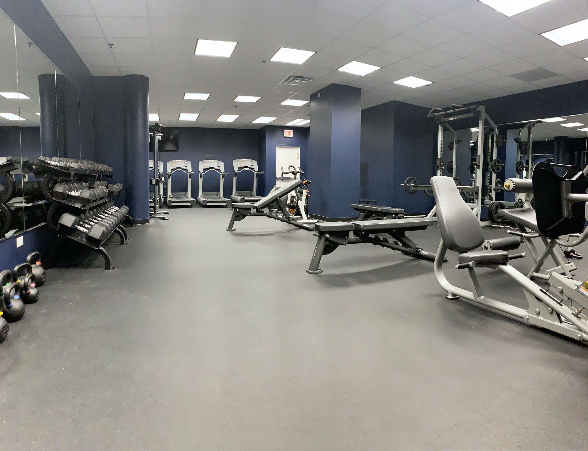A large gym with a lot of exercise equipment