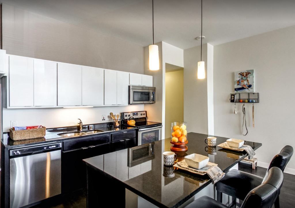 A kitchen with stainless steel appliances and a large island