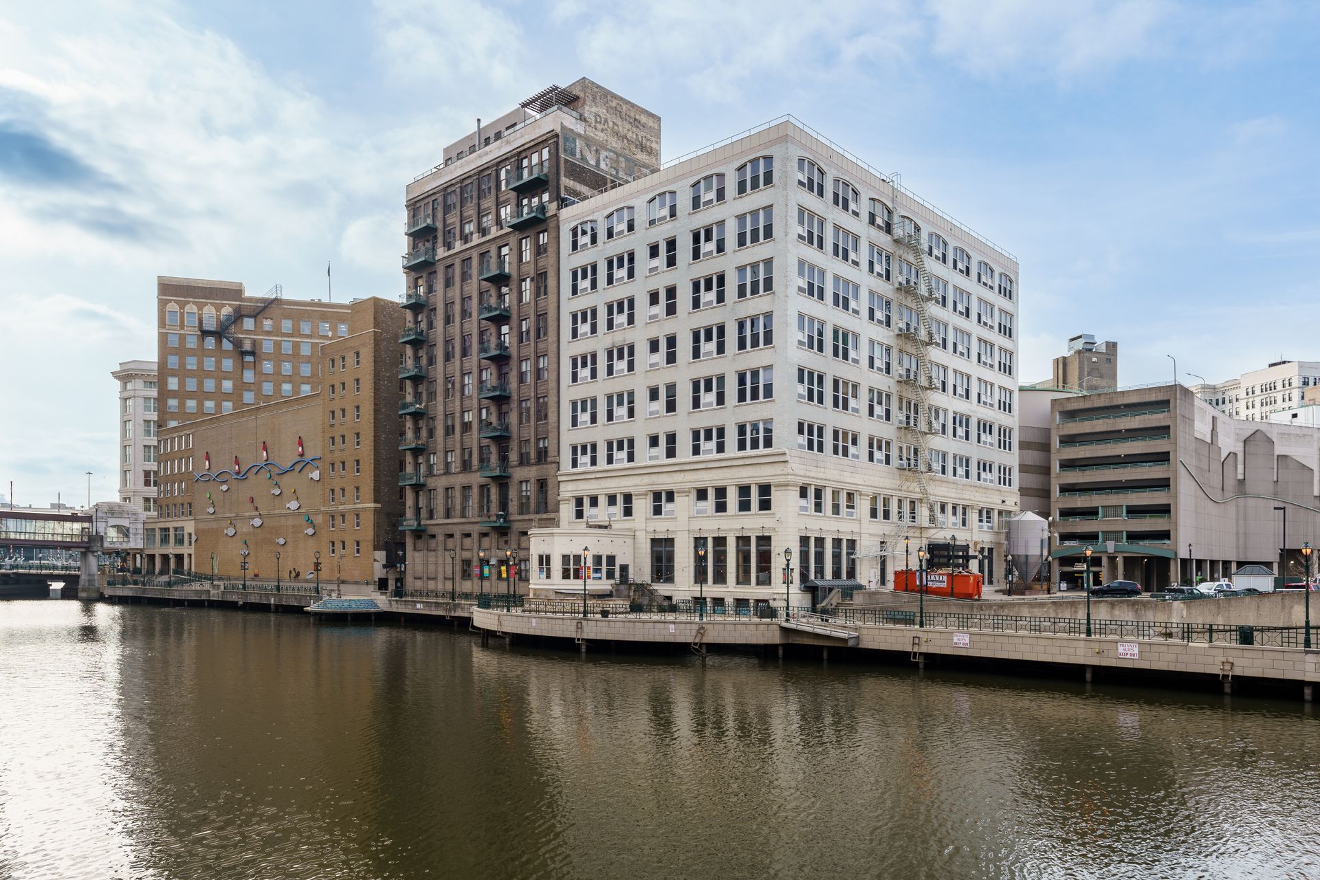 A large building is next to a body of water.