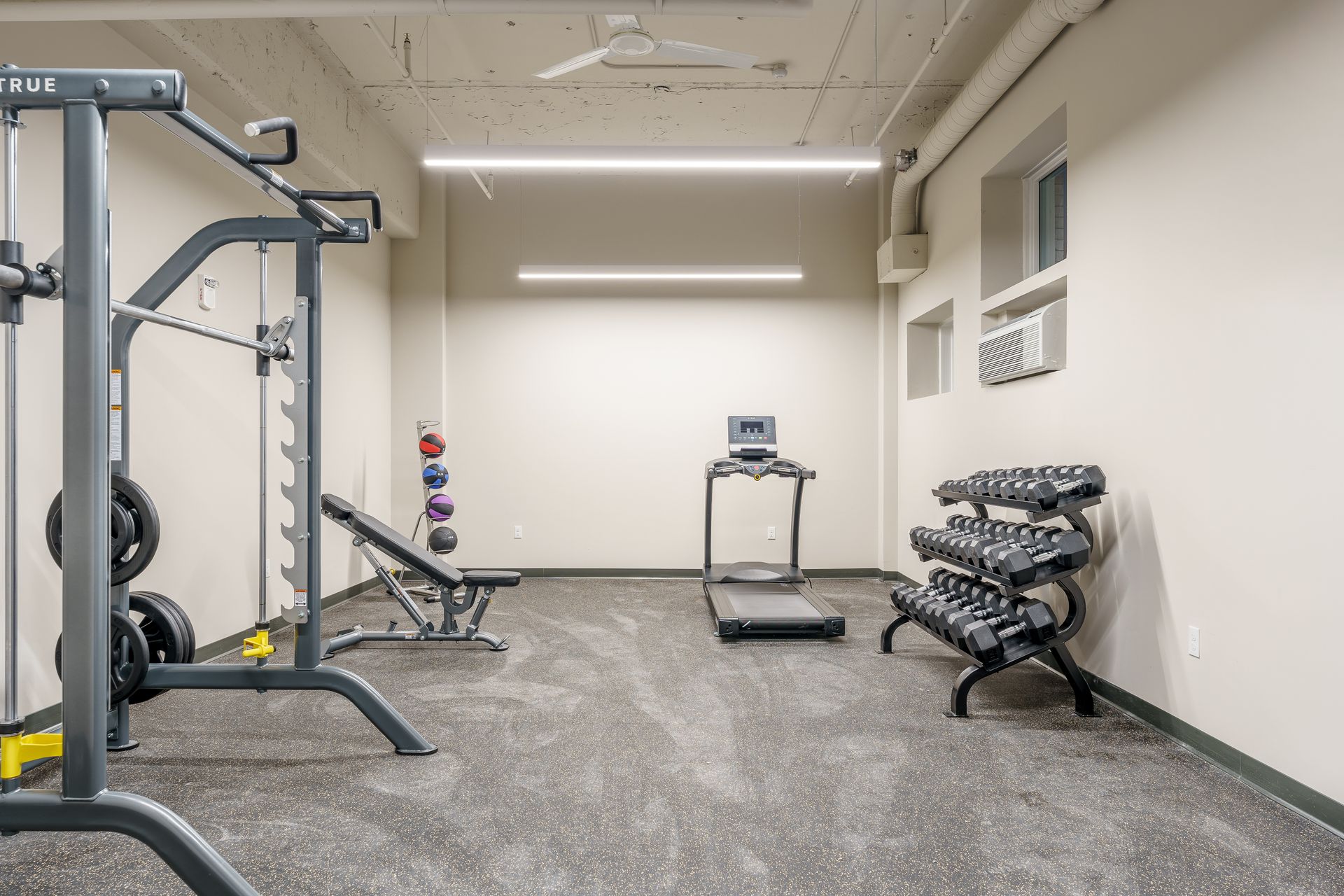 There is a treadmill in the middle of the room.