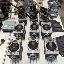 A bunch of engine parts are sitting on a table.