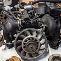 A bunch of engine parts are sitting on top of each other on a table.