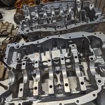 A close up of a metal engine block on a table.