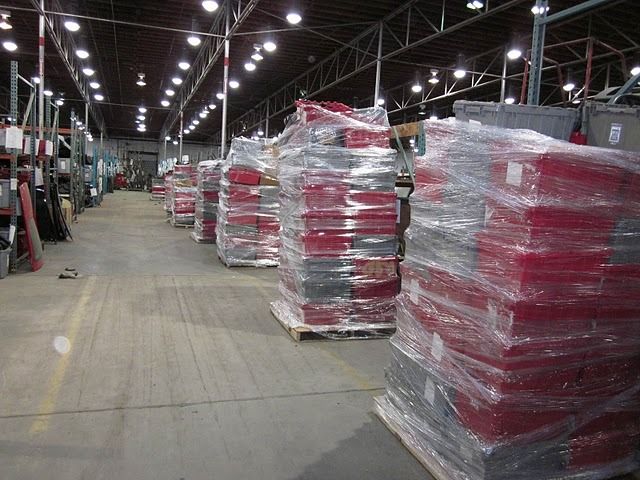 A warehouse filled with lots of boxes wrapped in plastic
