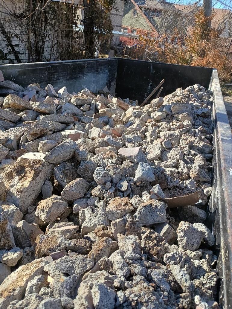 Pile of rubble in a dumpster, likely construction debris.
