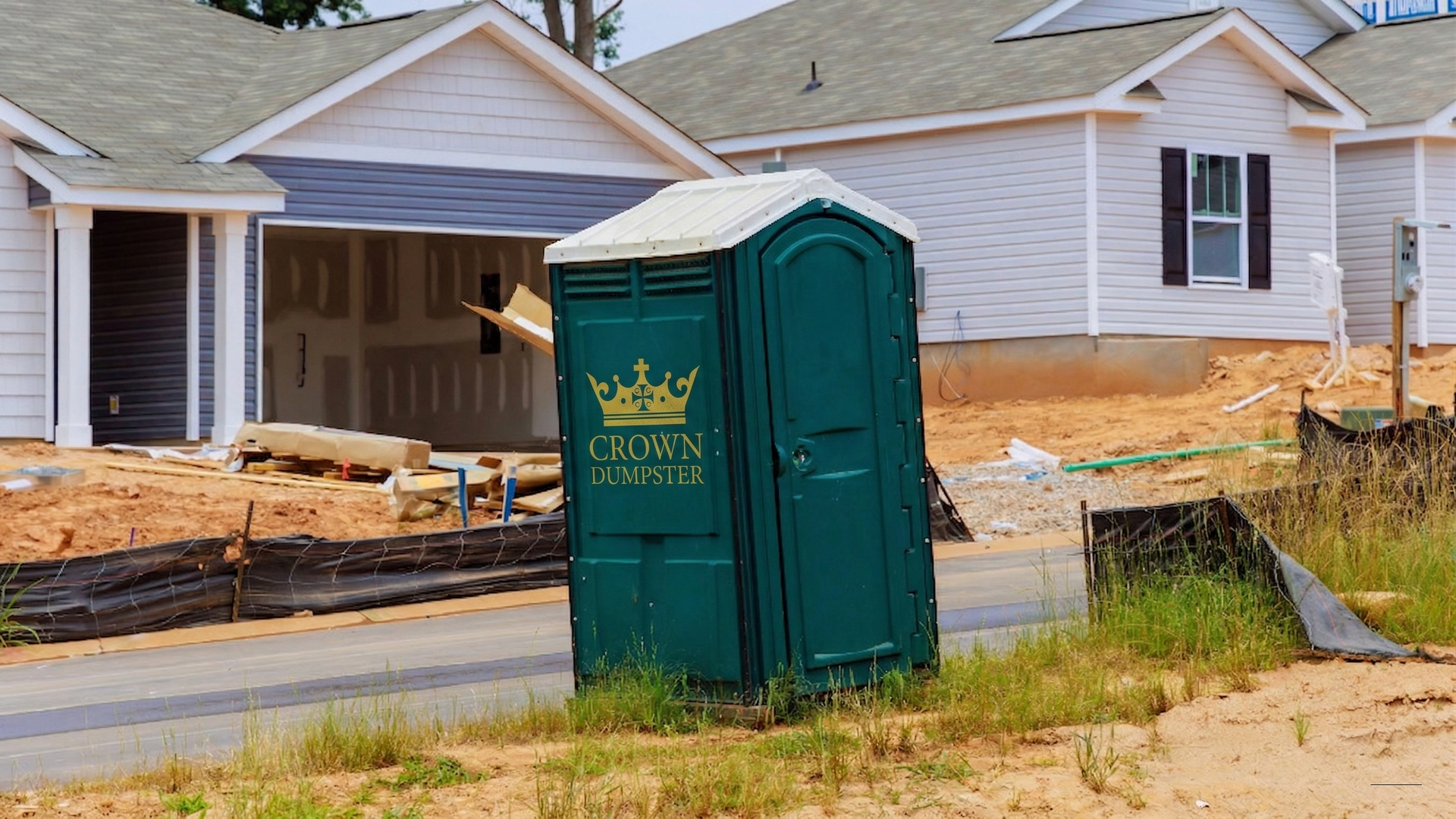 A front loader sorts scrap metal at a recycling center with a blue sky and power lines in the background.