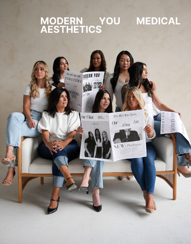 A group of women are sitting on a couch holding newspapers.