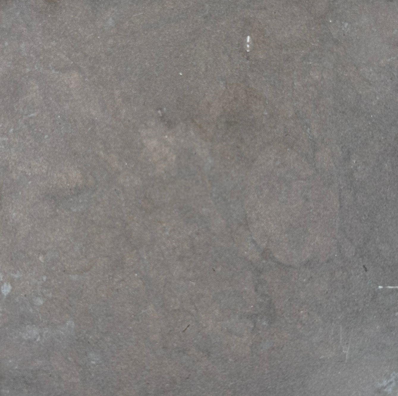 Szara, plamista, teksturowana powierzchnia.