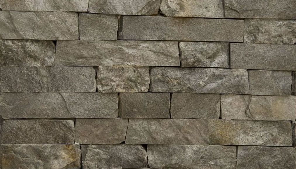 Szary kamienny mur z cegły.