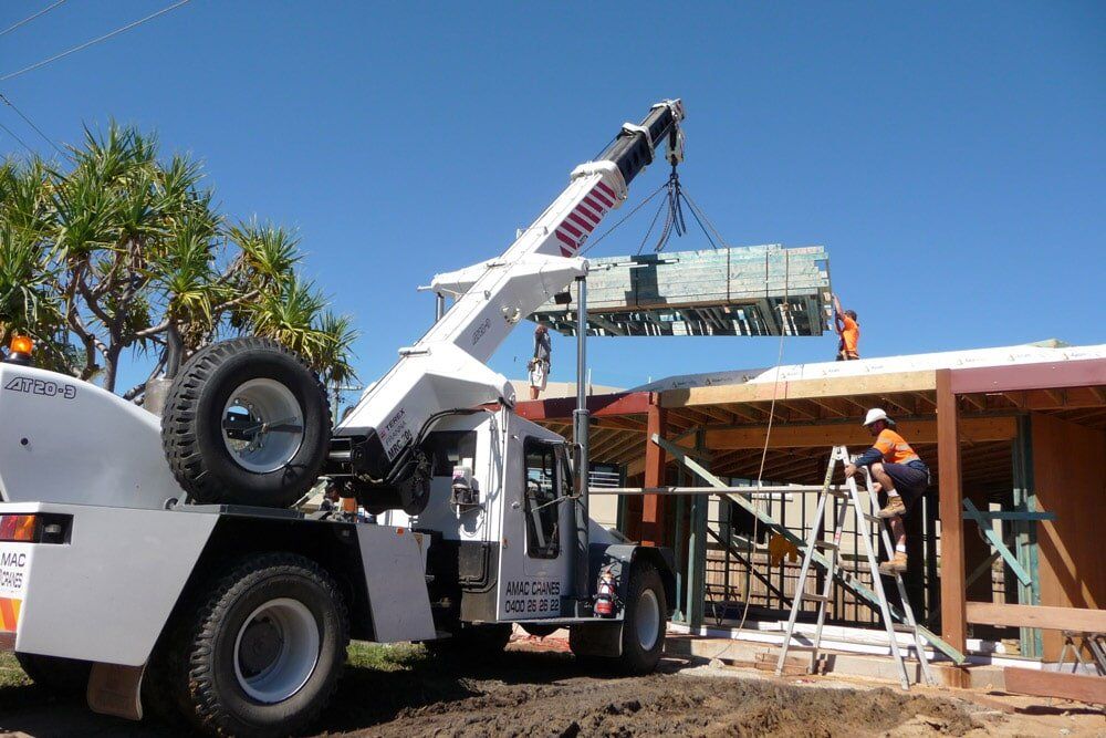 A mobile crane hire on the Sunshine Coast lifting timber frames - AMAC Cranes