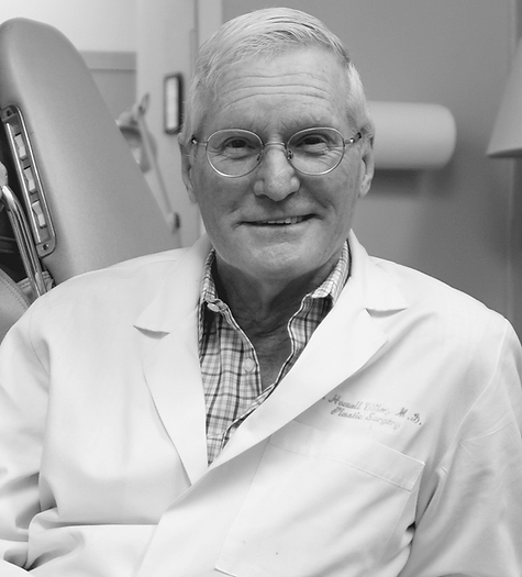 A black and white photo of a man in a lab coat