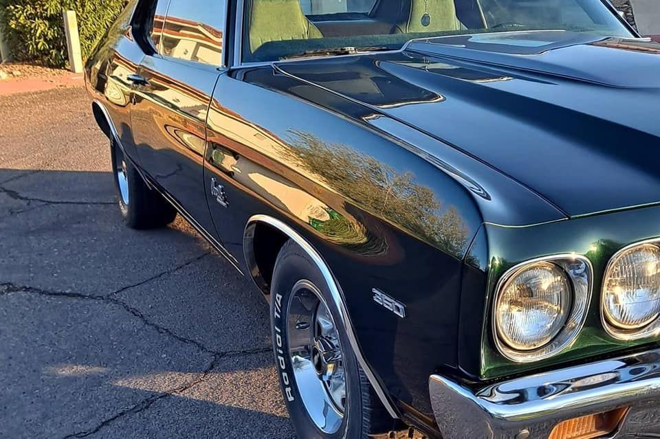 A black car is parked on the side of the road.