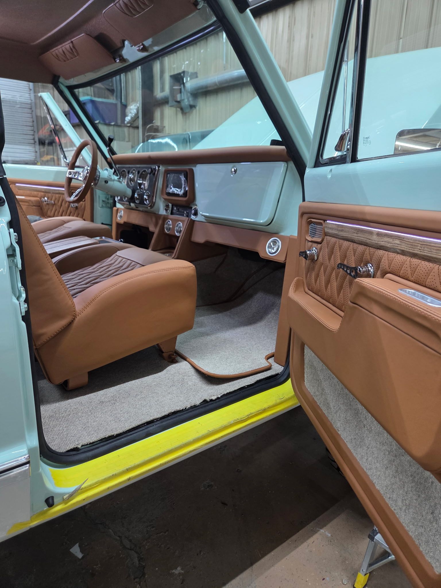 Light blue classic SUV interior with tan and brown leather accents.