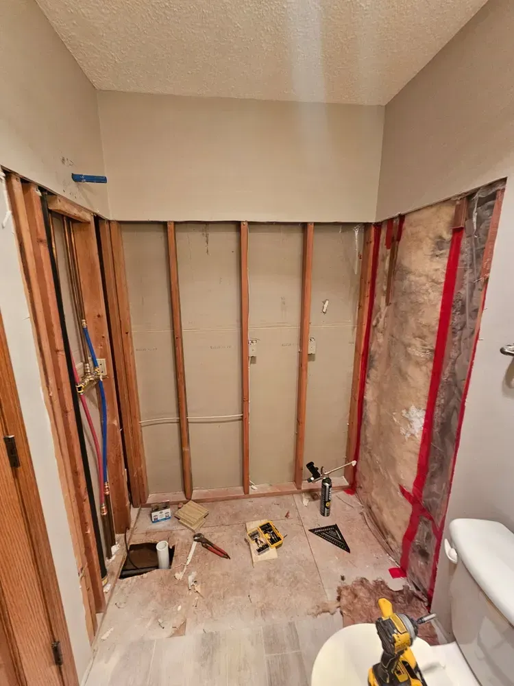 A bathroom under construction with a toilet and a sink.