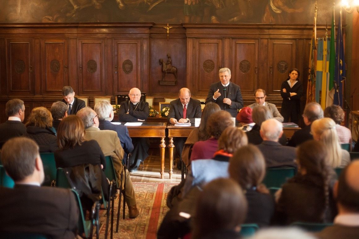 Un gruppo di persone è seduto in una stanza e guarda una presentazione.