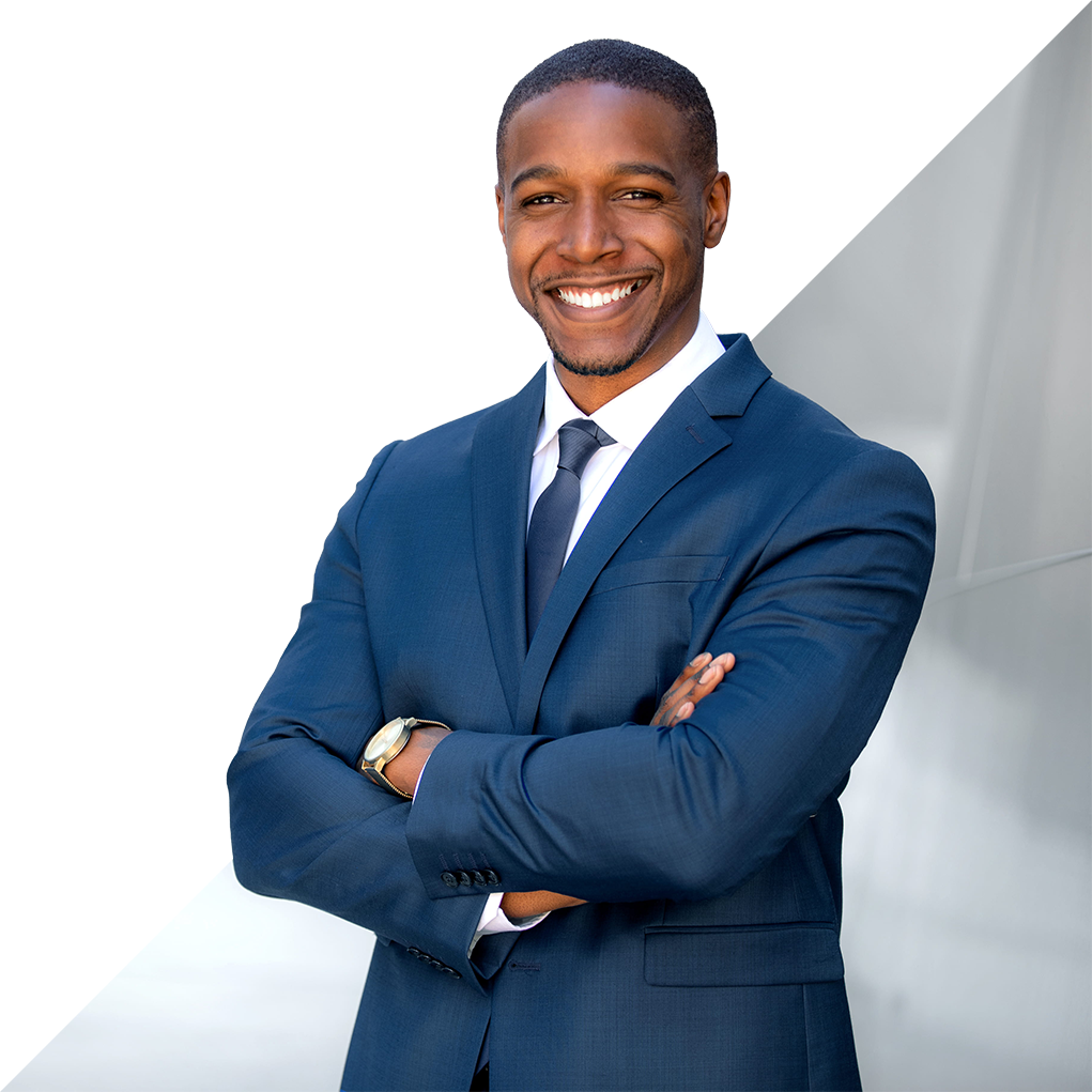 Man in blue suit, arms crossed, smiling. Modern architectural background.