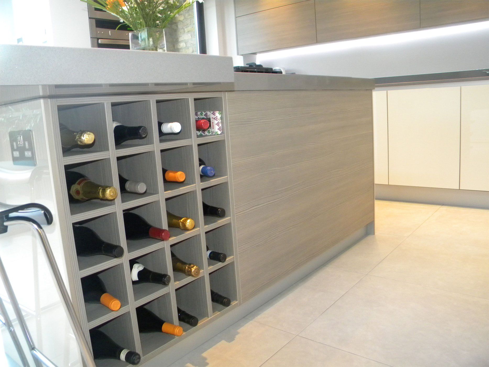A built in wine rack within a kitchen island.