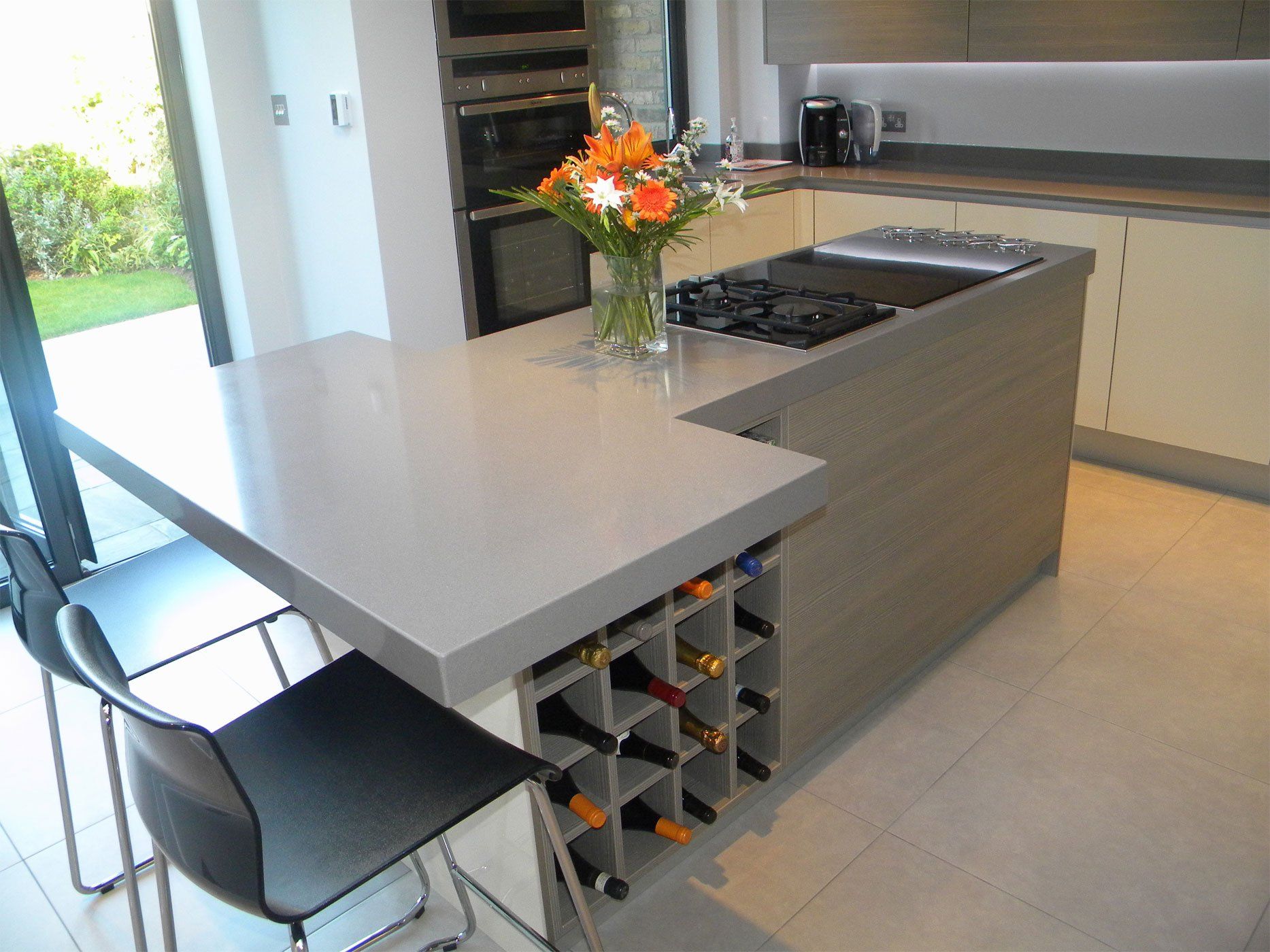 Kitchen island with seating, built in wine rack and integrated hob. 