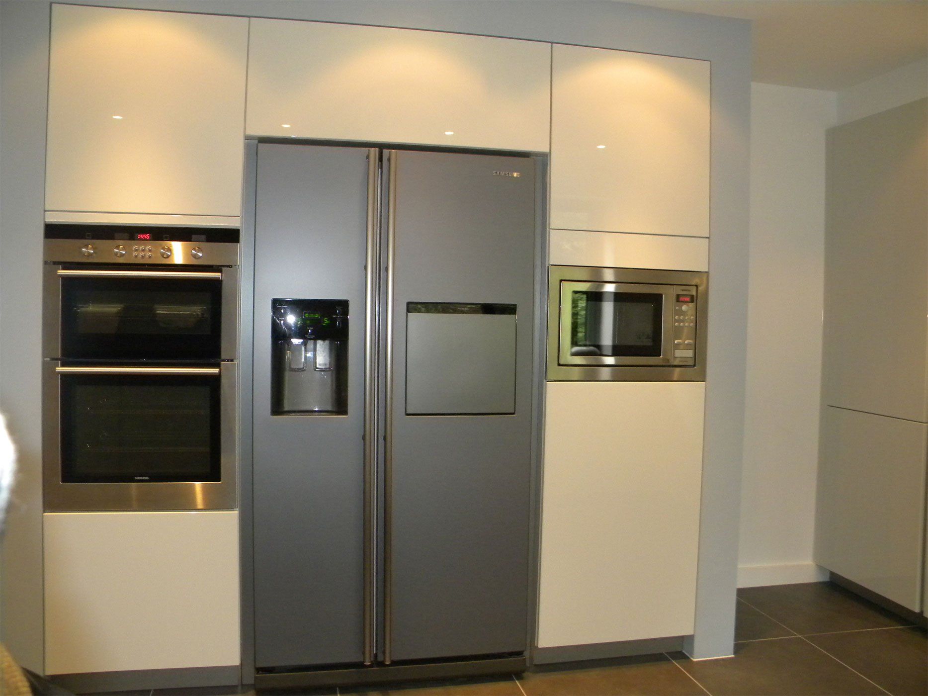 Built-in kitchen appliances including an oven fridge and microwave.