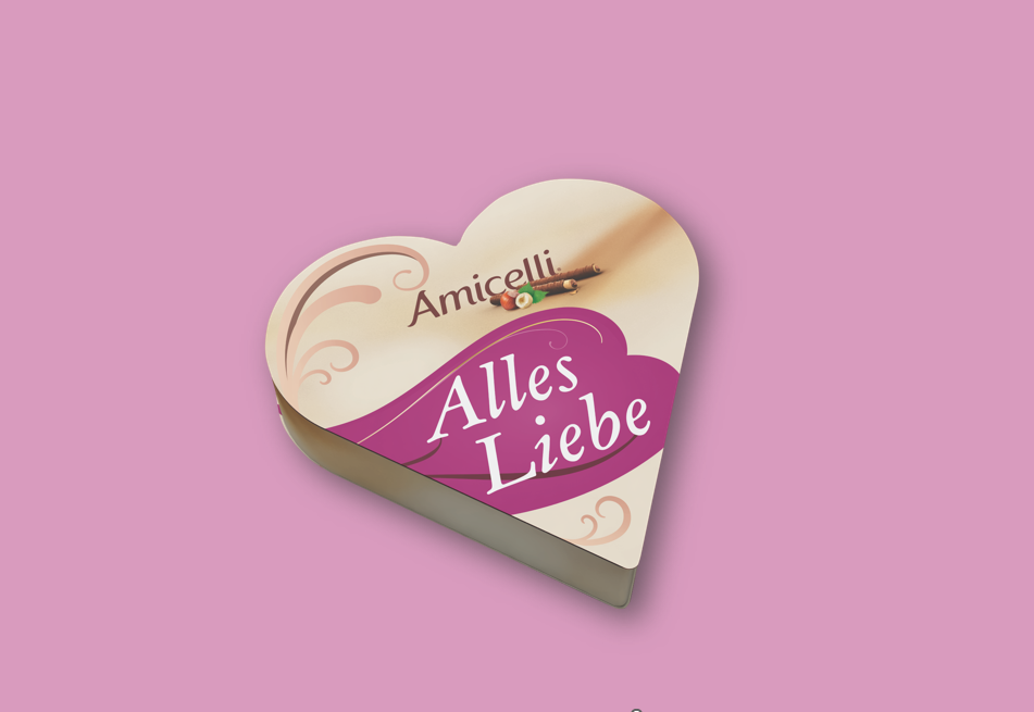 A box of amicielli sits on a table next to a vase of paper flowers