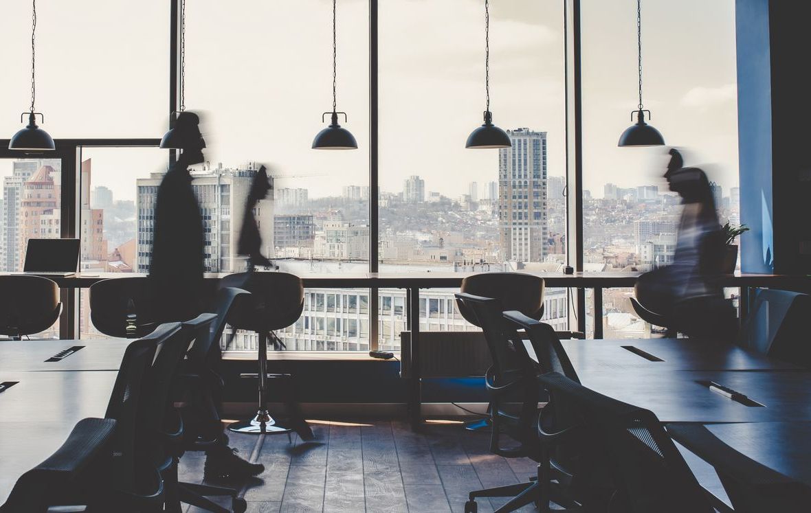 Un groupe de personnes sont assises à des tables dans un bureau.