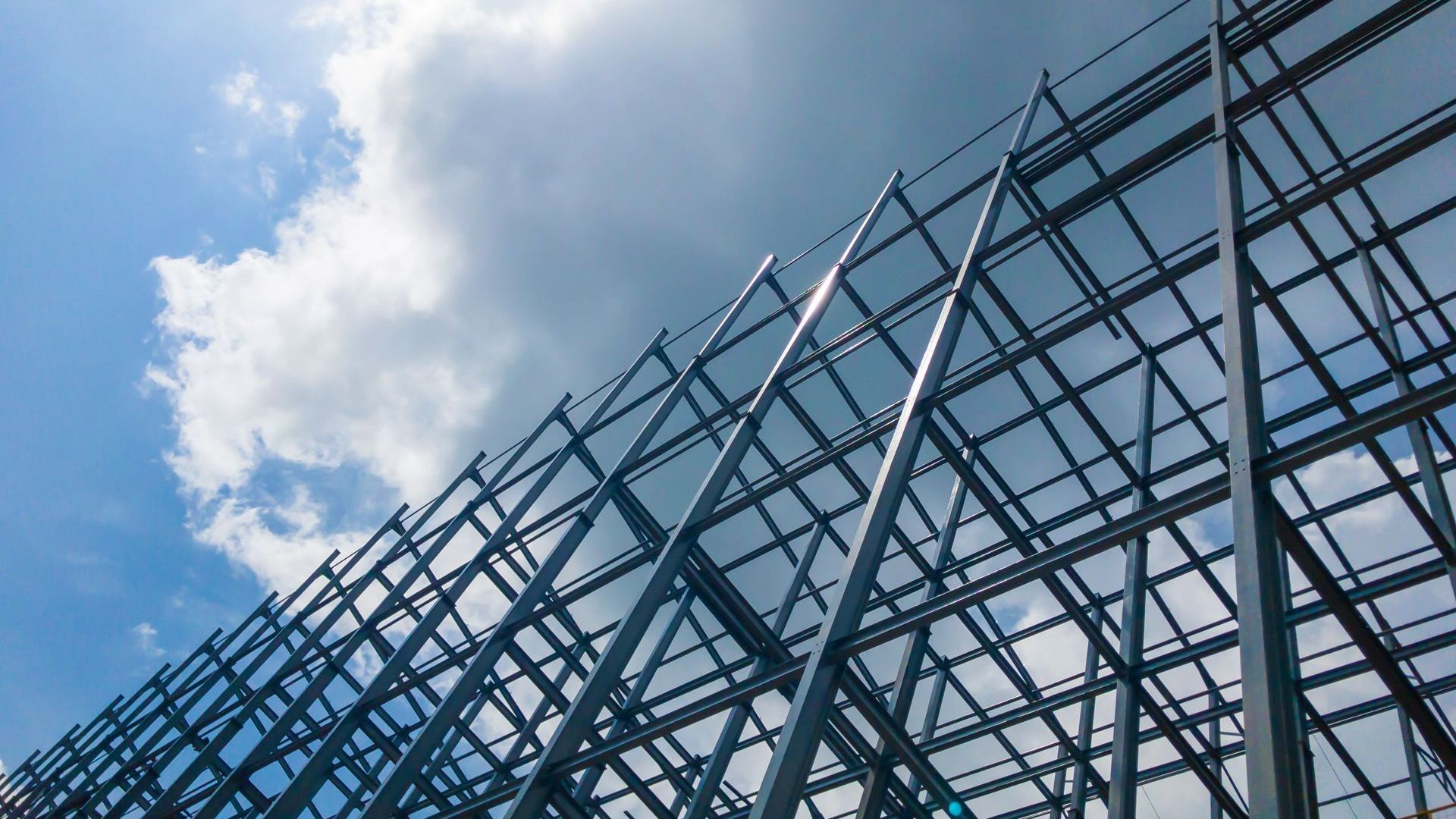 A building under construction with a blue sky in the background.