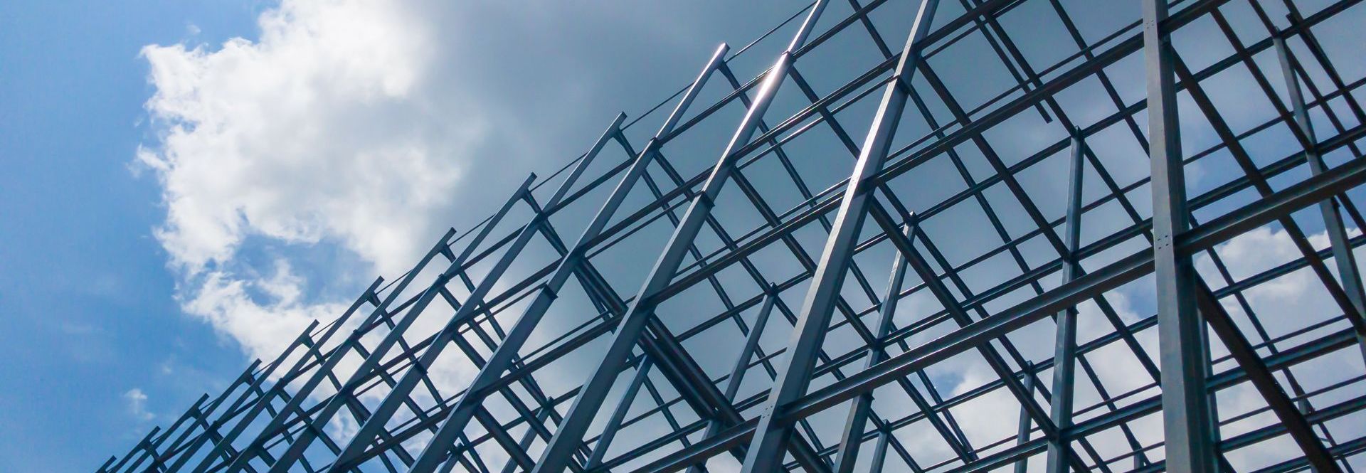 Looking up at a fence with a blue sky in the background